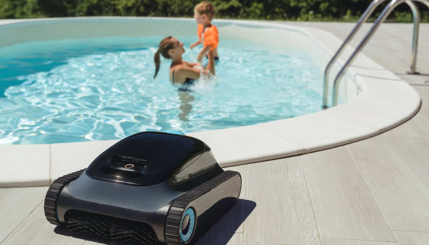 a-robotic-pool-cleaner-on-the-poolside Maintain Your Pool During Winter Without the Hassle